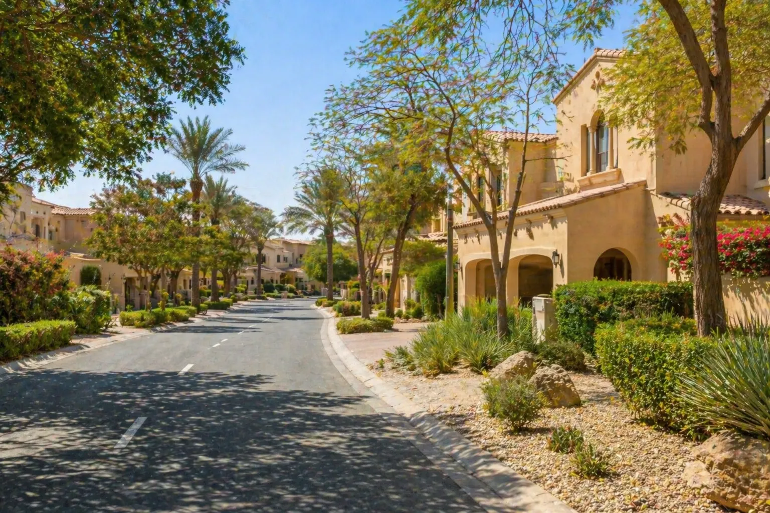 Mature villas on the street in Arabian Ranches, Dubai, surrounded by established trees and desert-inspired landscaping.