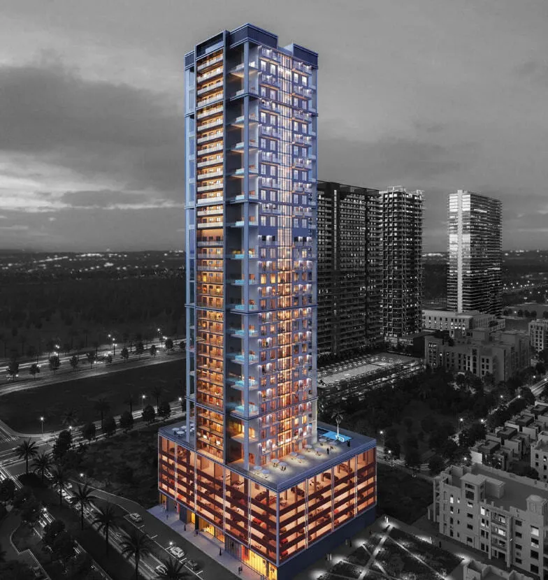 Binghatti Onyx tower illuminated at night in Jumeirah Village Circle